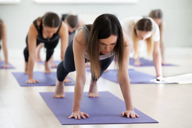 istock Group of young sporty people in Plank pose 967775208