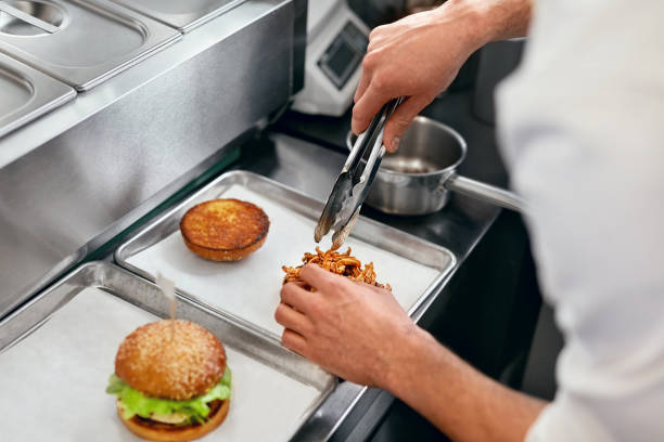 istock Burger Restaurant. Closeup Chef Cooking Burgers In Kitchen. 967780610