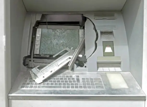ATM machine with broken glass following a robbery