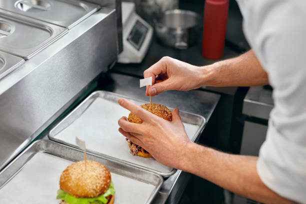 istock Burger Restaurant. Closeup Chef Cooking Burgers In Kitchen. 967780730
