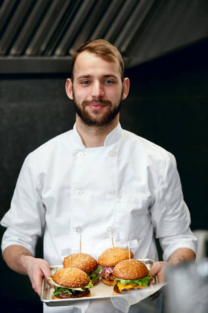 istock Chef With Burgers In Restaurant Kitchen 967784194