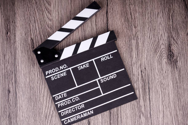 istock holding clapper board or slate film concept On wooden table. 967785564