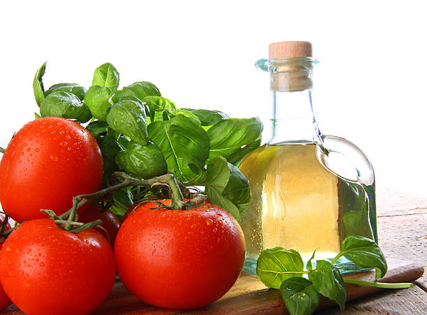 Tomatoes with fresh basil and olive oil stock photo