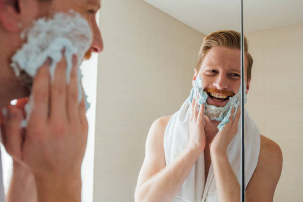 istock Happy man applying shaving gel on his face 967799844
