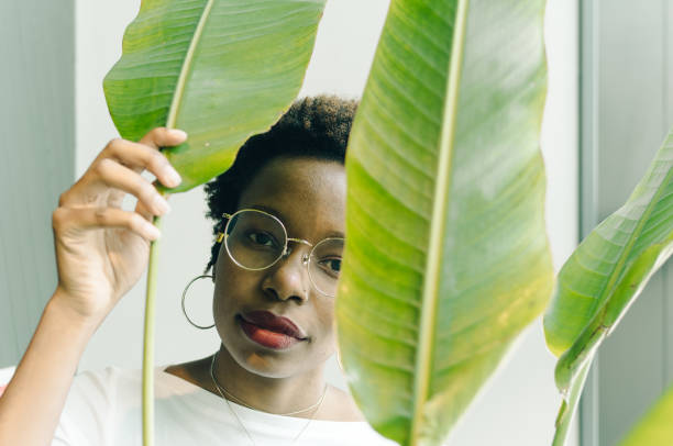 istock Young woman with plant. 967803124