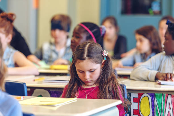 istock Sad schoolgirl in a classroom 967809048