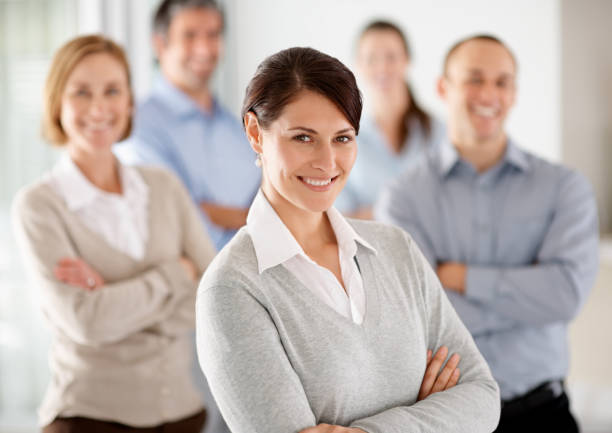 istock Confident business woman standing with colleagues 96781352