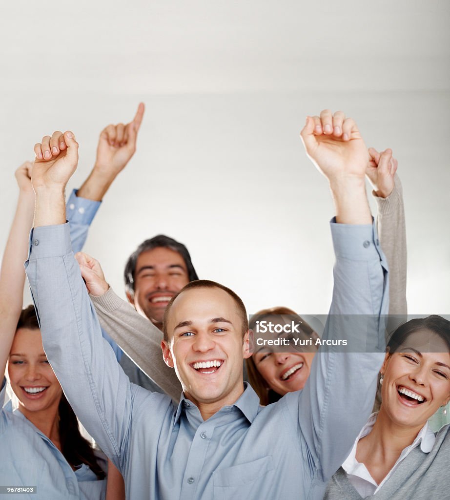 Business colleagues with their hands raised Group of excited business colleagues with their hands raised Celebration Stock Photo