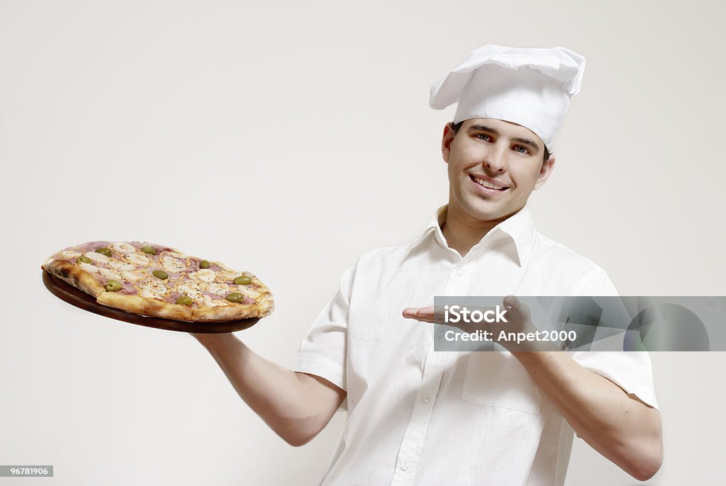 Portrait of happy attractive cook with a pizza in hands  Cut Out Stock Photo