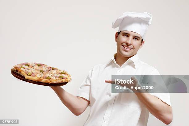 Portrait Of Happy Attractive Cook With A Pizza In Hands Stock Photo - Download Image Now