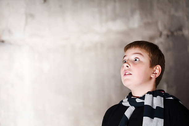 istock Young boy looking up with hope in eyes  copy space 96782255