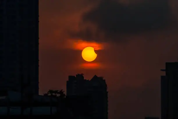 Photo of BANGKOK - MARCH 9, 2016: Partial and total solar eclipse over building in  Bangkok city, Thailand, Asia.