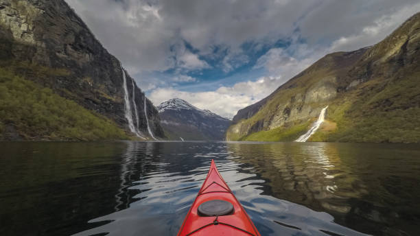 Kayaking in Geirangerfjord Kayaking towards the Seven Sisters waterfall in Geirangerfjord, Norway geirangerfjord stock pictures, royalty-free photos & images