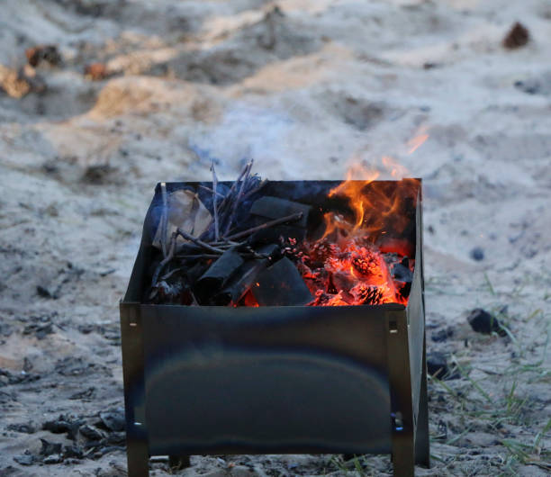 istock burning grill. on brazier with hot coals is a grill. black charcoal burns and smoldering 967872082