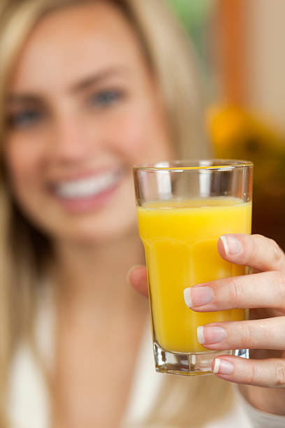 istock Woman Drinking Orange Juice 96789186