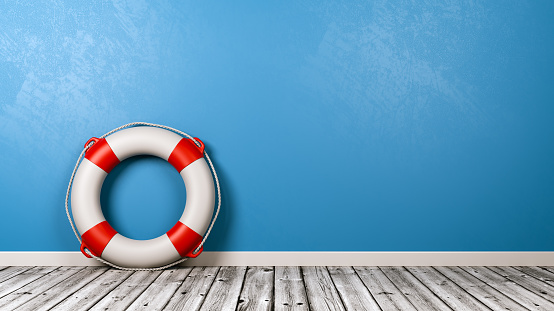 Lifebuoy on Wooden Floor Against Blue Wall with Copy Space 3D Render