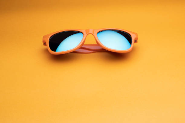 istock Fashionable sunglasses on a yellow surface 967902974