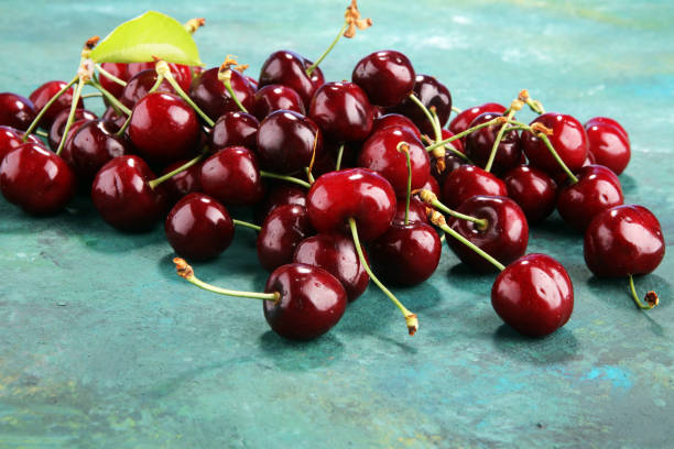 istock Cherry. Red fresh bunch of cherries on the table 967903530