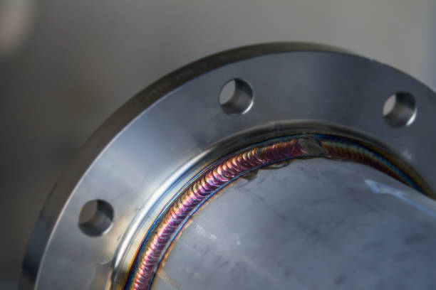 istock Steel weld joined pipe to plate by arc welding process . rainbow color.with copy space 967906220