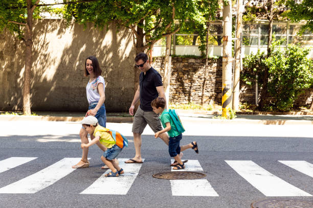 istock Family crossing the street...having fun 967907086