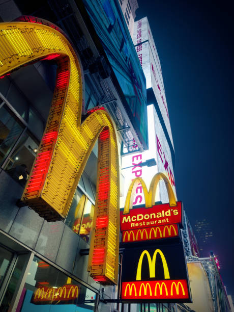 マックのドナルドのロゴは、夜にミッドタウンをアット タイムズ スクエアします。 - brand name yellow red business ストックフォトと画像