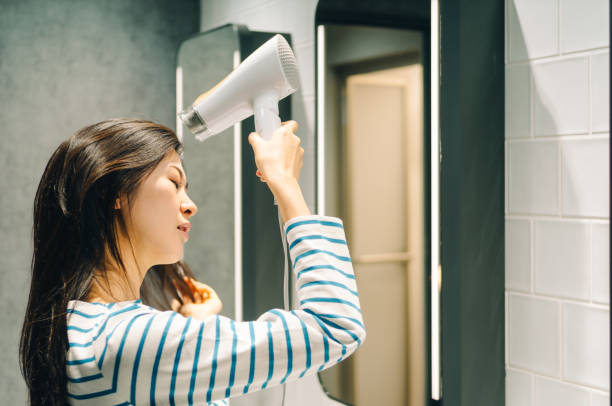istock Young women drying her hair. 967910942