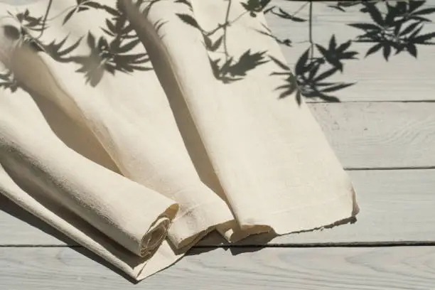 Hemp homespun fabric on a white wooden surface