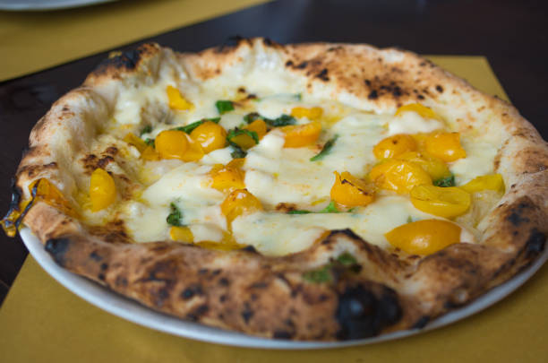 neapolitanische pizza mit gelben tomaten - pizza pastry crust oven meat stock-fotos und bilder