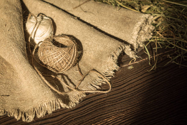 istock Hemp canvas and threads on a dark wooden surface 967917446