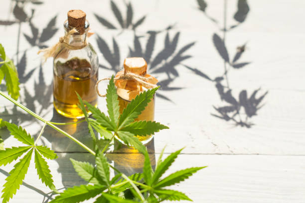 istock Hemp oil in small bottles on a white wooden surface 967917704