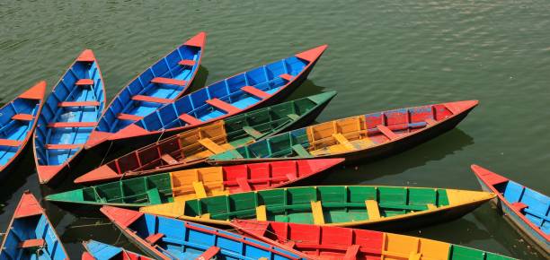 istock Multi colored timber rowing boats on Fewa lake, Pokhara, Nepal. 967918672