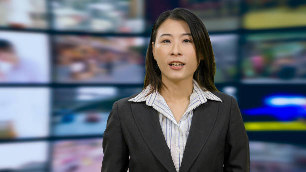 istock Asian anchorwoman in TV studio 967921320