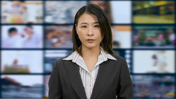 istock Asian anchorwoman in TV studio 967921426