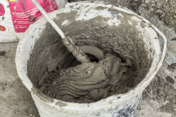 istock Concrete mixing with electrical drill and mixer. Wet Facade Insulation 967922854
