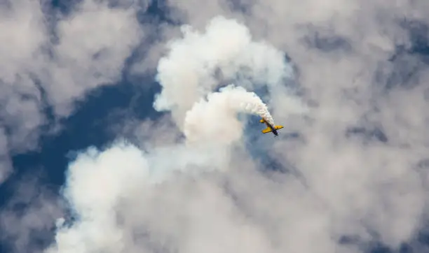 airplane making smoke stunts in the air