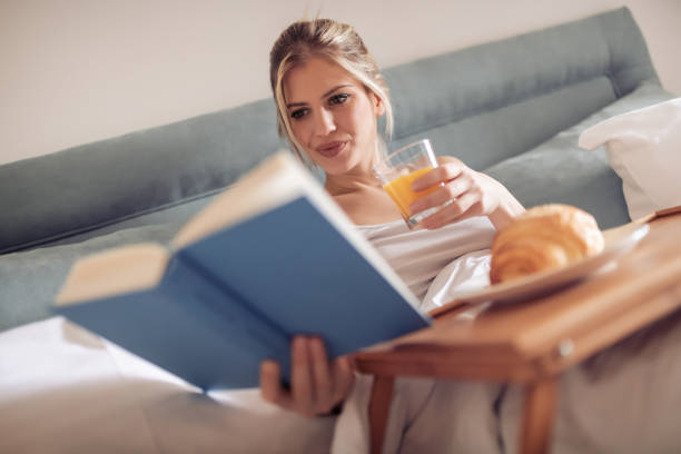 istock Beautiful woman having breakfast in bedroom 967930896