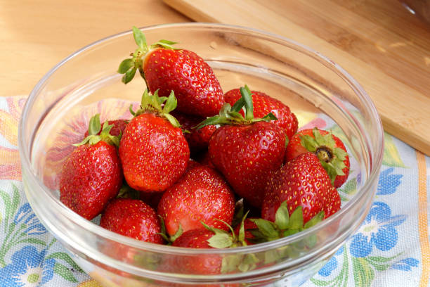 Fresh strawberry in a transparent salad bowl stock photo