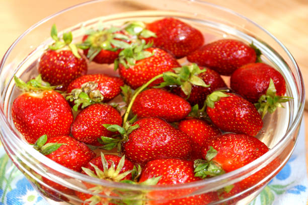 Fresh strawberry in capacity with water stock photo