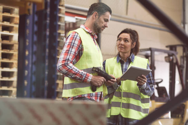 istock Man and woman working in a warehouse 967941924