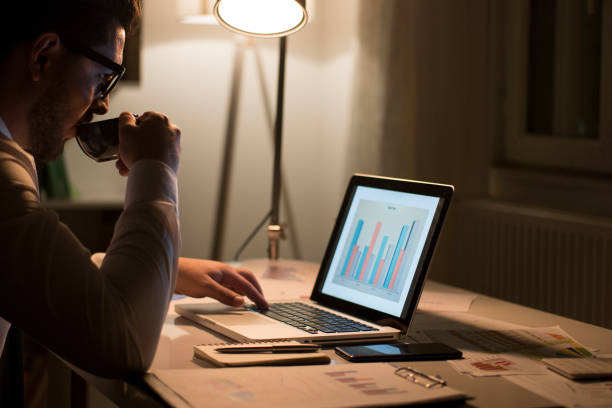 istock Young businessman working late on laptop 967948068