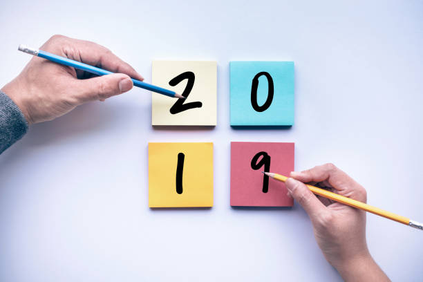 istock 2019 text with male and female hand writing pencil on notepaper 967951106