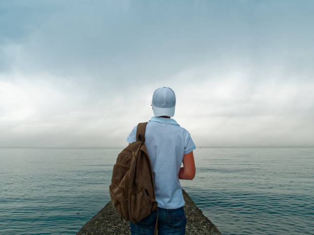 istock Tourist on the beach in cloudy weather 967953230