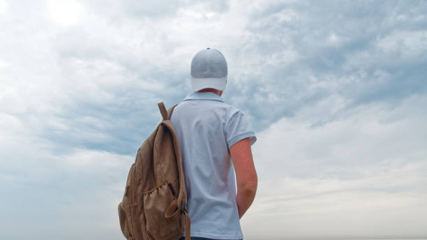 istock Tourist on the beach in cloudy weather 967953248