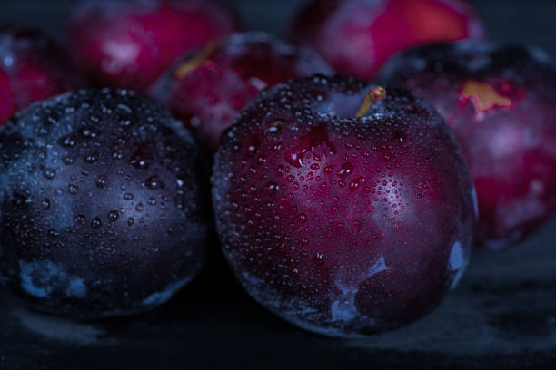 red plums on blue plate