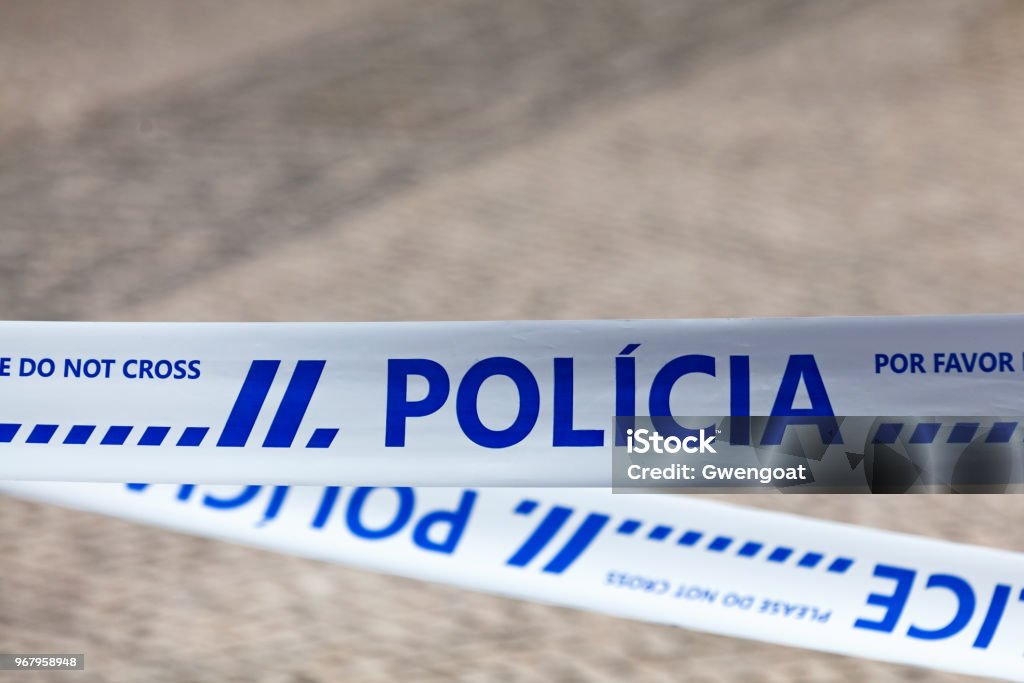 Portuguese police tape Police tape with written in it in Portuguese "Polícia". Police Force Stock Photo