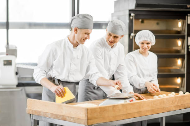 istock Bakers forming dough for baking at the manufacturing 967969306