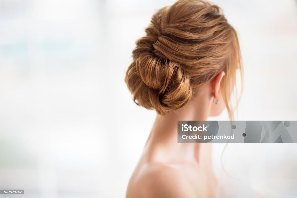 Beautiful elegant wedding hairstyle Beautiful elegant wedding hairstyle. Bride. Blond girl with curly hair styling Hairstyle Stock Photo