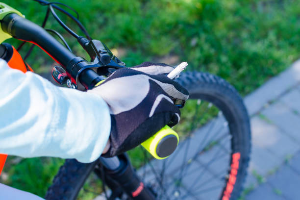 istock A cyclist rides a bicycle and holds a cigarette 967980326