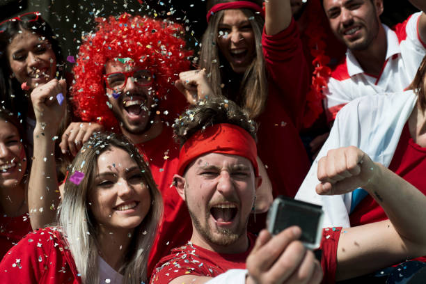istock Group of Fans Taking a Video 967993800