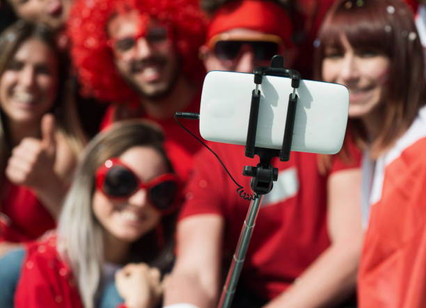 istock Group of Fans Taking a Selfie 967993928